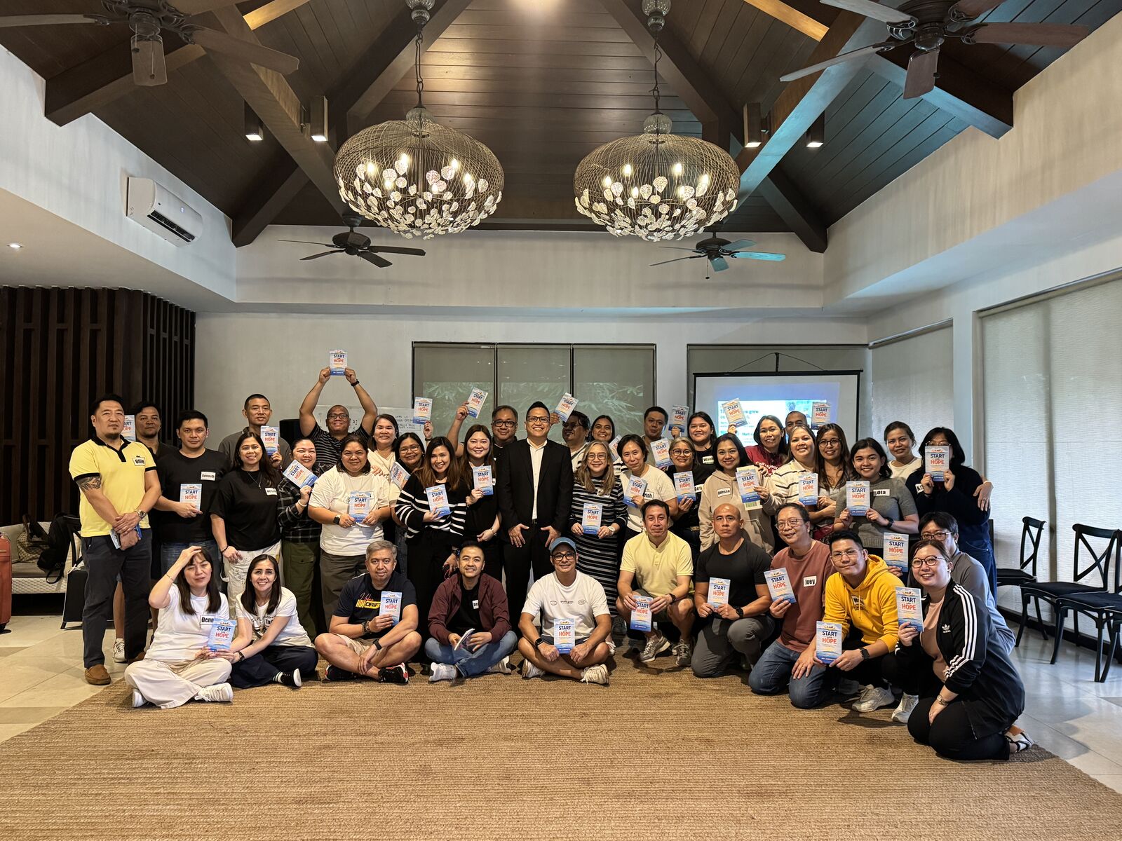 Global Payments leaders holding copies of Start with HOPE with Jay Jaboneta in Tagaytay