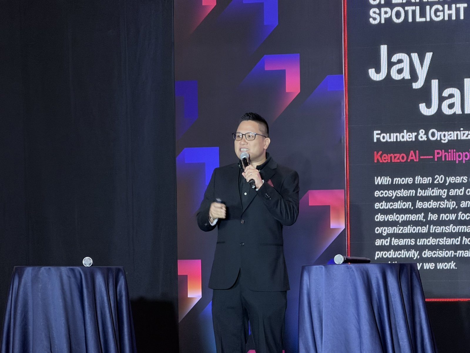Jay Jaboneta on stage at PGDC Leadership Connect 2026 beside the Keynote Speaker Spotlight screen